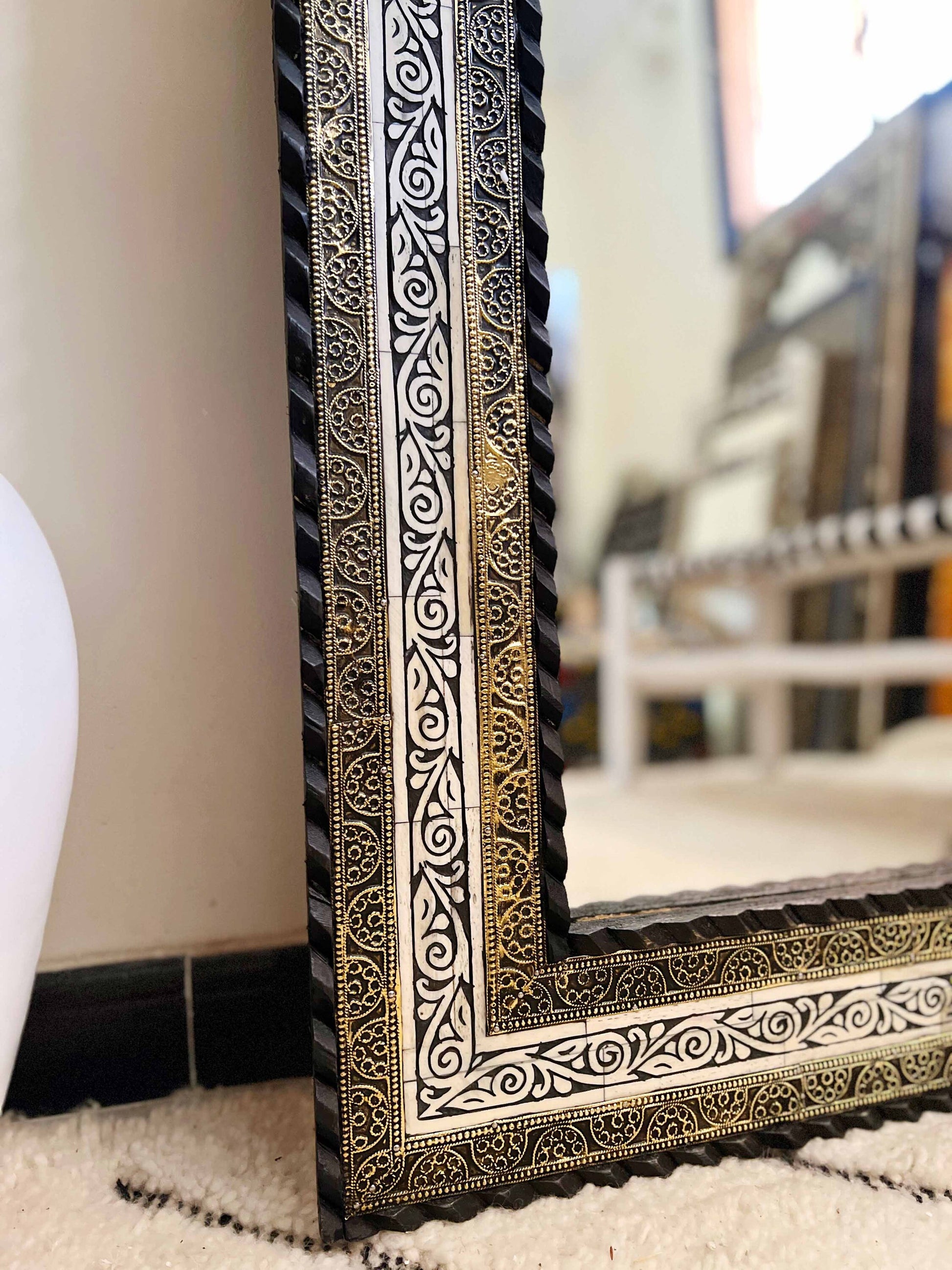 a black and white picture frame sitting on top of a rug