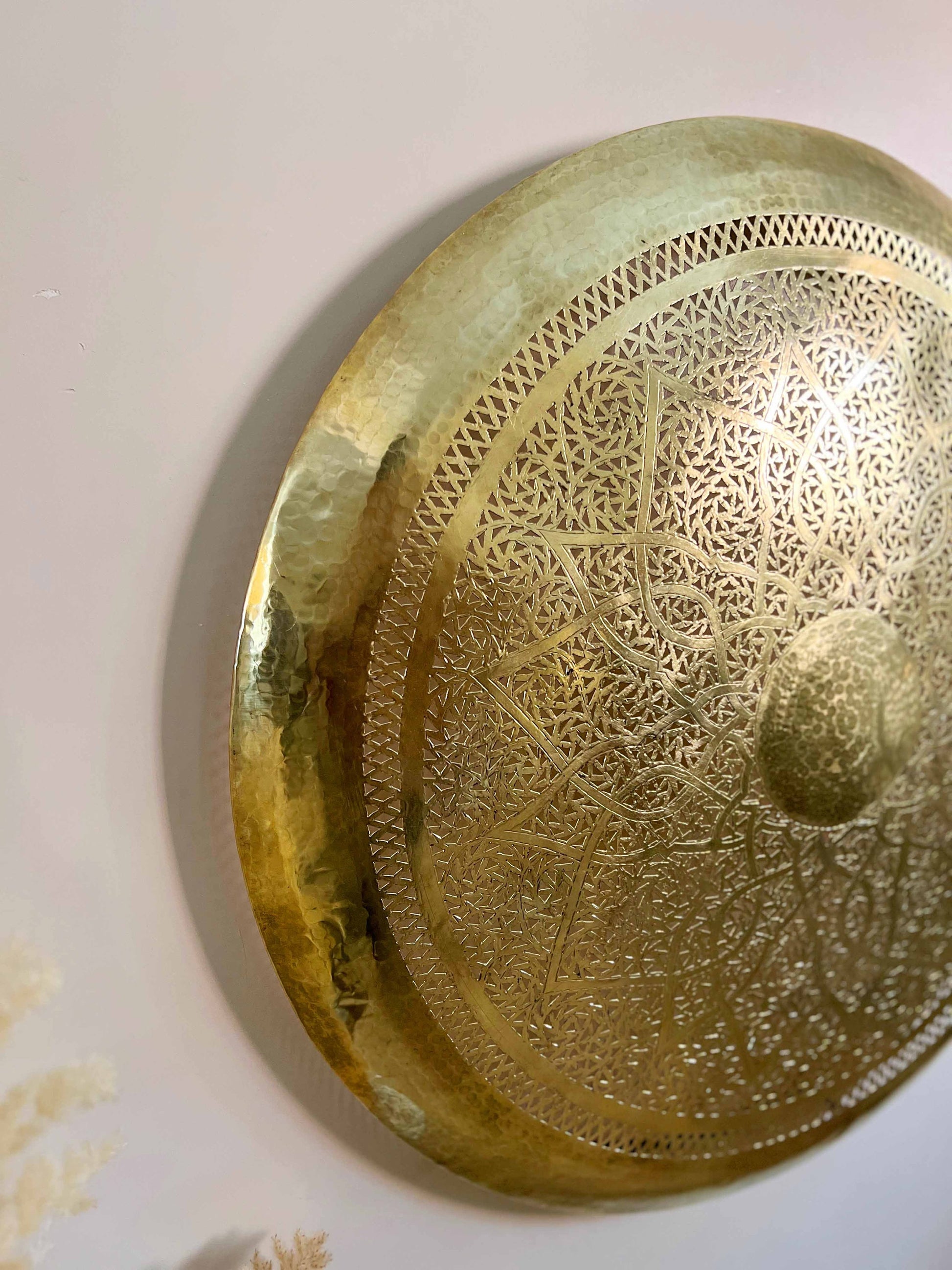 a gold plate is hanging on a wall