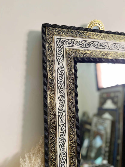 a mirror sitting on top of a table next to a stuffed animal