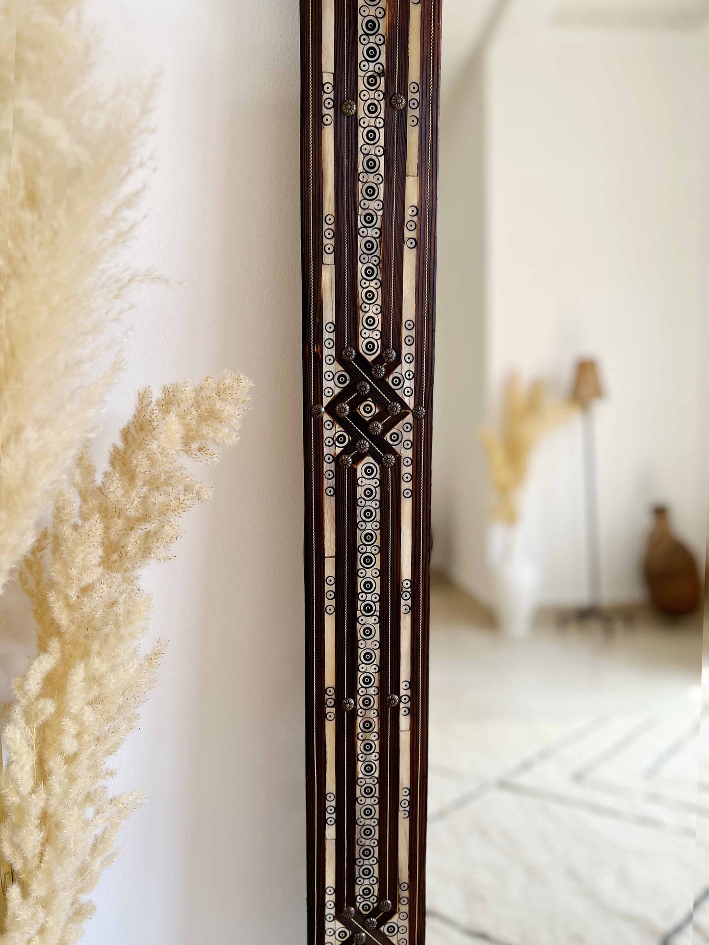 a tall wooden clock sitting on the side of a wall