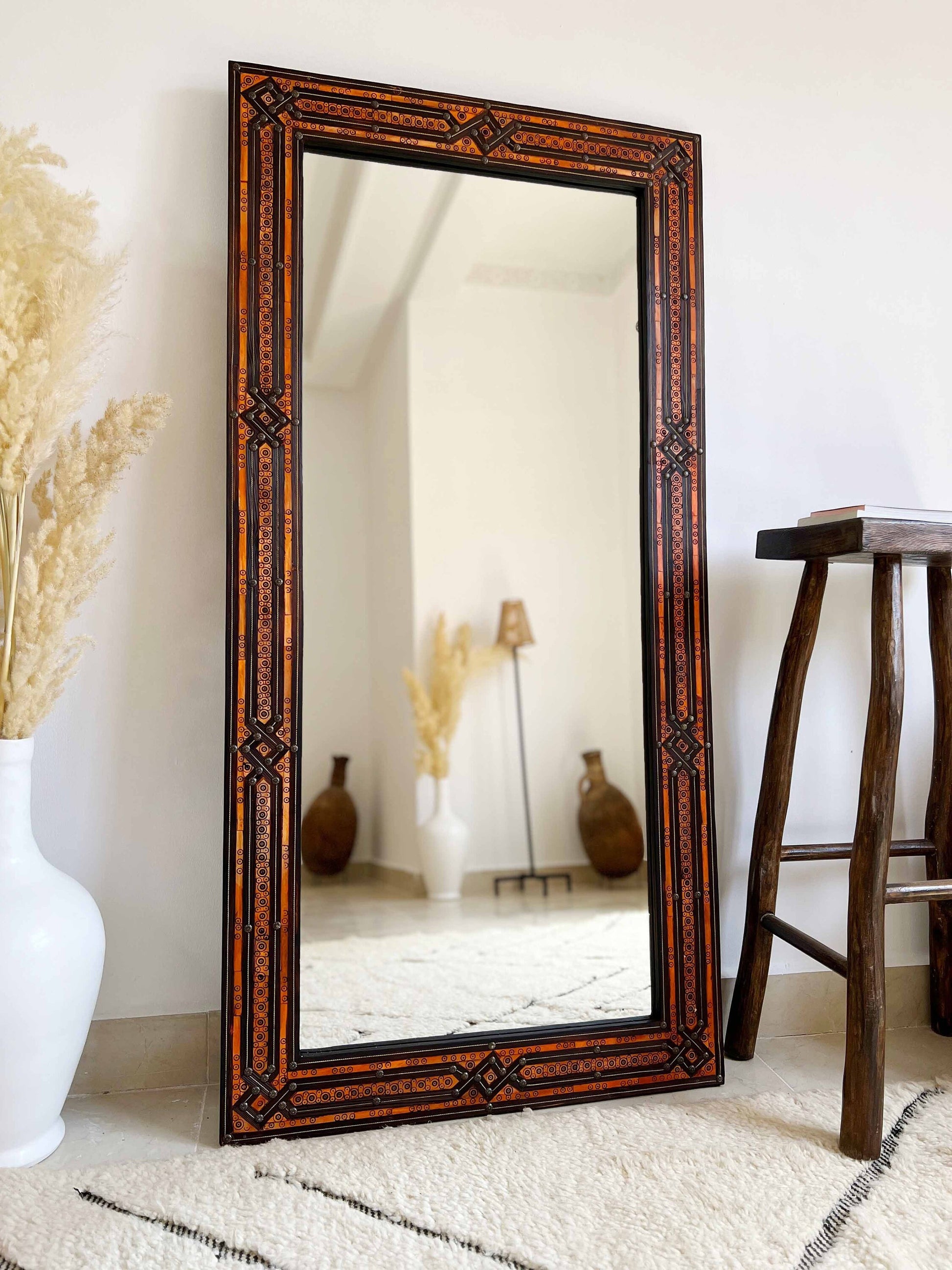 a large mirror sitting on top of a white rug