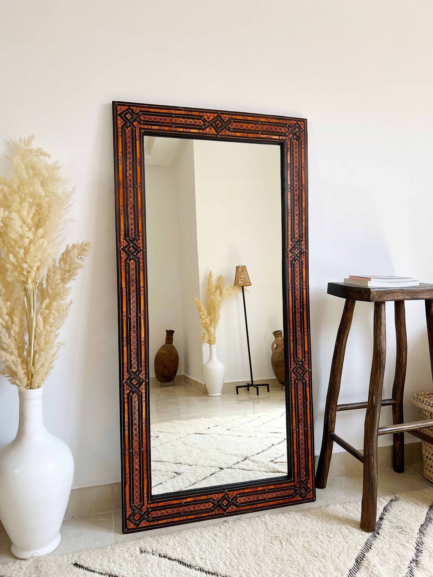 a full length mirror sitting on top of a white rug