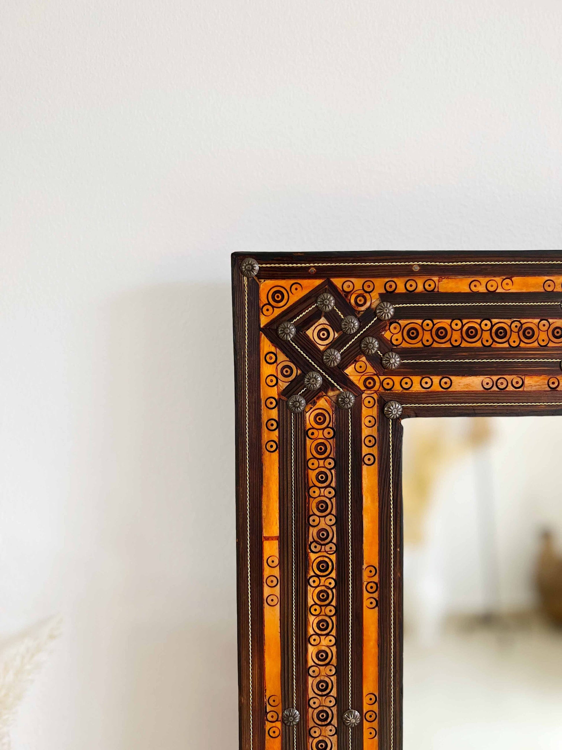 a mirror sitting on top of a wooden table