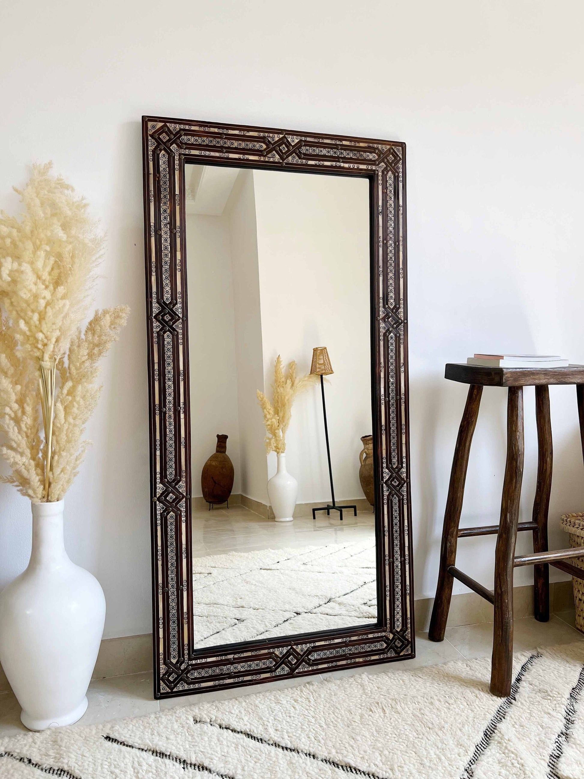 a large mirror sitting on top of a white rug