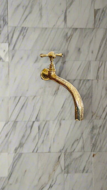 a gold faucet with a white background