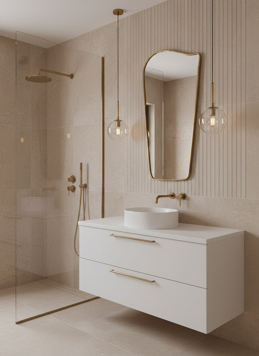 Wave brass mirror above white vanity with gold fixtures