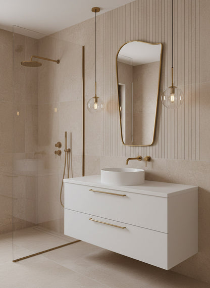 Wave brass mirror above white vanity with gold fixtures