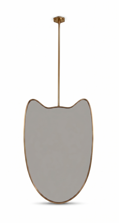Organic suspended brass mirror on a white background with slim ceiling rod and brass frame.