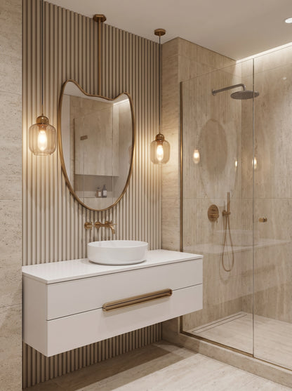 Sculptural brass hanging mirror above a floating white vanity in a modern travertine bathroom.