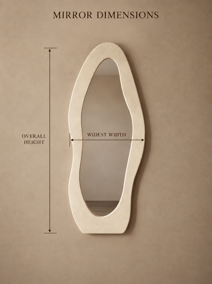 An asymmetrical cream-colored wall mirror with dimension callouts showing overall height, widest width, and a center label, set against a warm beige background with the text 'MIRROR DIMENSIONS' at the top.