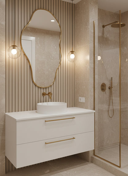 Organic brass bathroom mirror above white vanity
