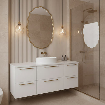 Oval wavy gold mirror over white vanity in beige bathroom.