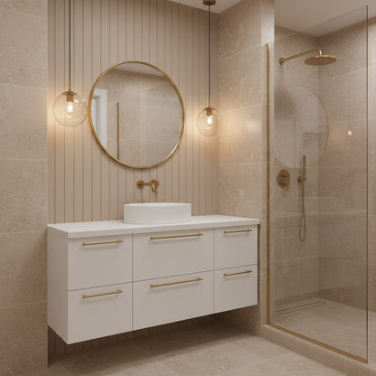 Round brass mirror above white vanity in modern bathroom