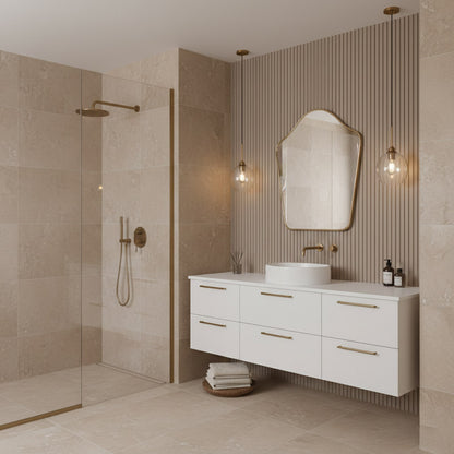 Arched top bathroom mirror above white floating vanity with brass fixtures