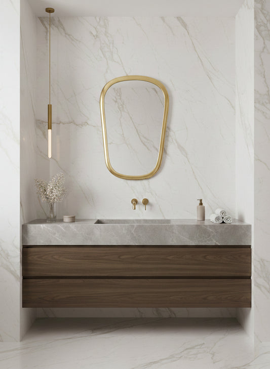 Brass mirror over marble bathroom vanity