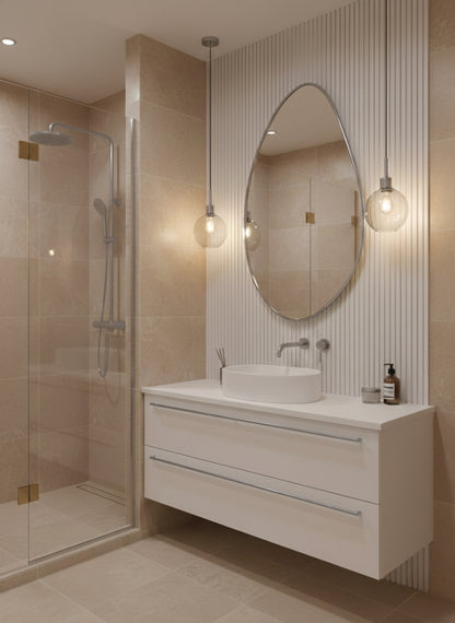 Silver asymmetrical brass mirror in modern beige bathroom.