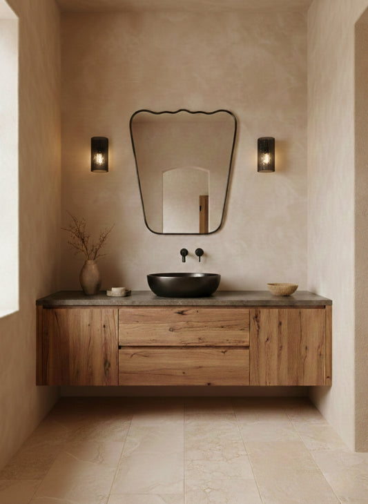 Wavy brass mirror in rustic bathroom