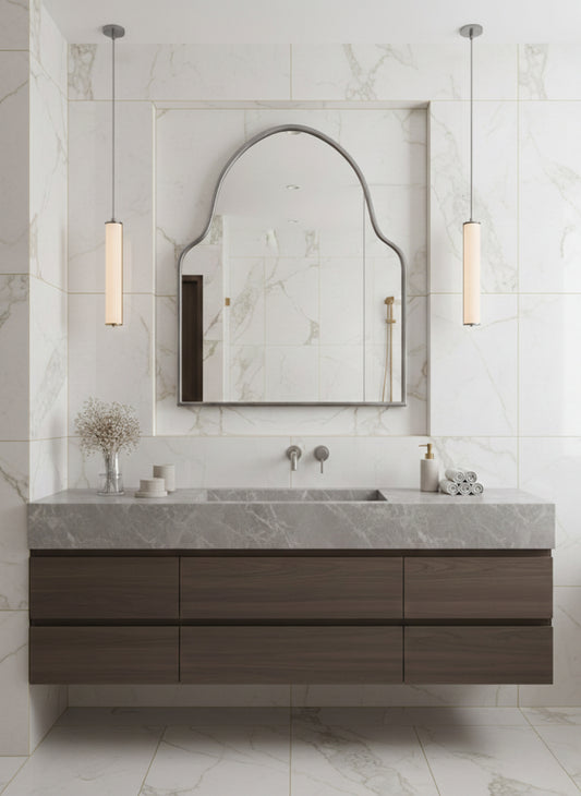 Silver brass arch mirror over marble vanity in luxury bathroom.