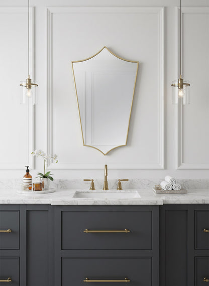Elegant shield brass mirror over classic white bathroom vanity