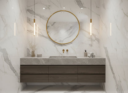 Round brass mirror above an elegant white fireplace mantel.