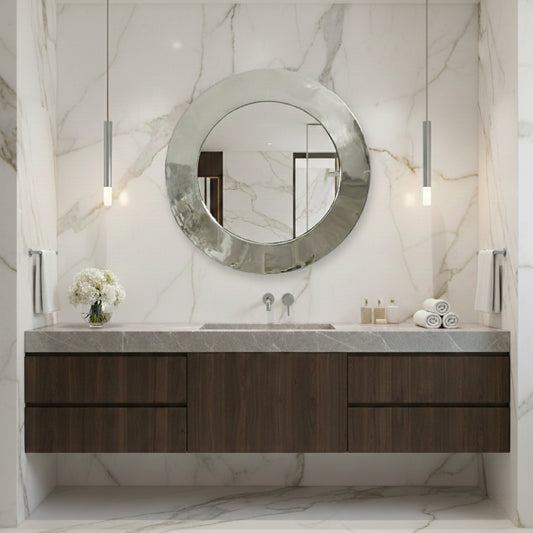 Modern bathroom vanity with round mirror and marble walls