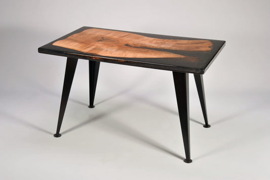 Wooden table with black metal legs on a white background