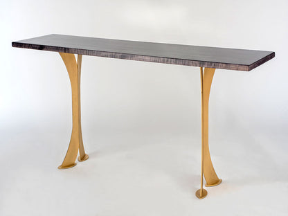 Table with a dark marble top and gold legs on a white background