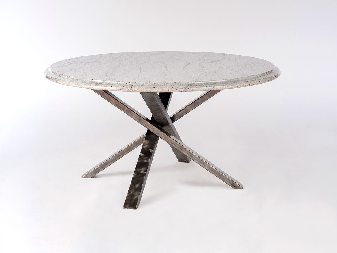 Round concrete table with metal legs on a white background