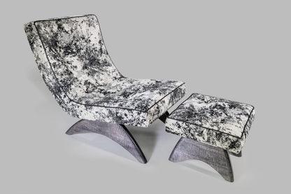 Modern lounge chair and ottoman with black and white pattern on a gray background