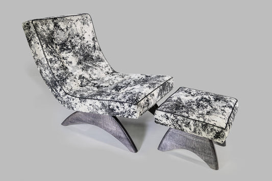Modern lounge chair and ottoman with black and white pattern on a gray background
