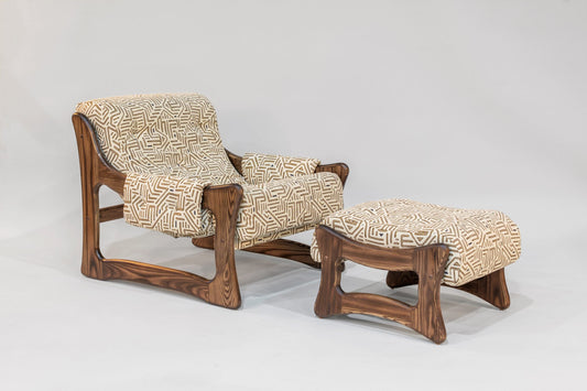 Wooden armchair and ottoman with patterned cushions on a white background