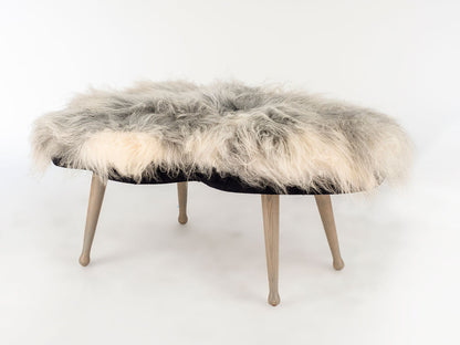 Fur-covered ottoman on a white background