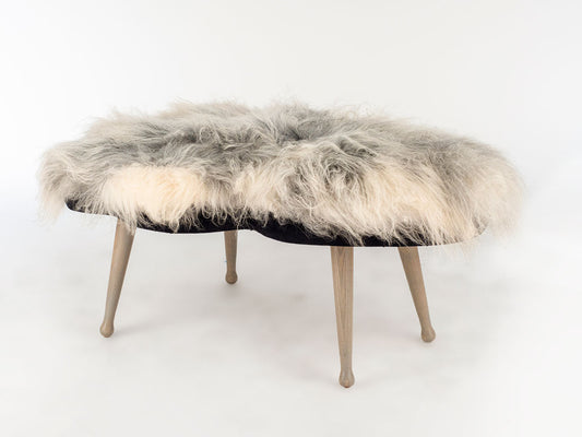 Fur-covered ottoman on a white background