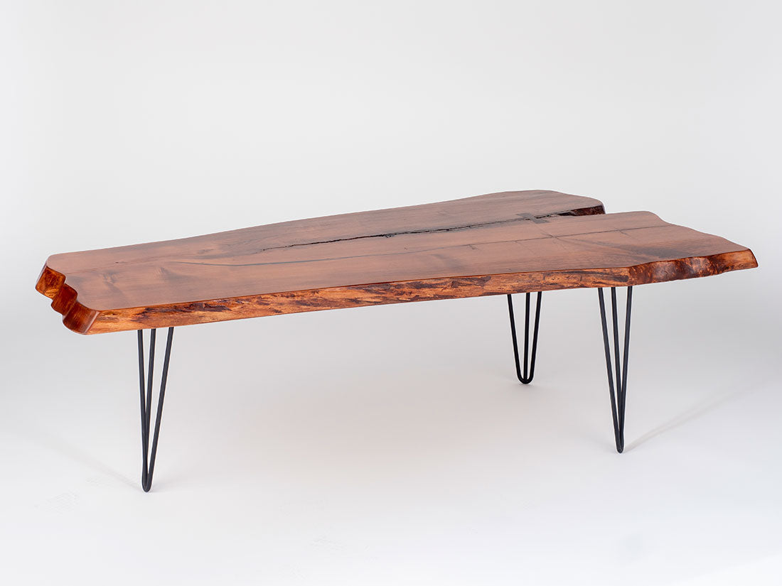 Wooden coffee table with black hairpin legs on a white background