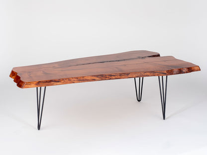 Wooden coffee table with black hairpin legs on a white background