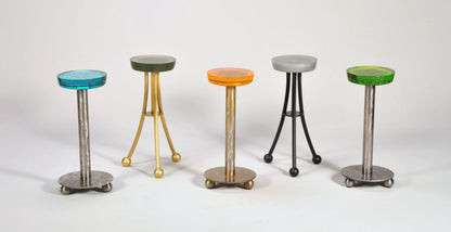 Five colorful stools with different designs on a white background