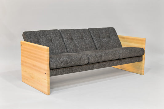 Gray sofa with wooden frame on a light gray background