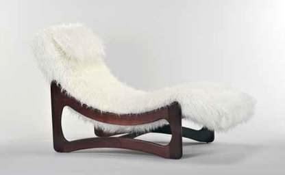 Modern chair with white fur cover on a light gray background