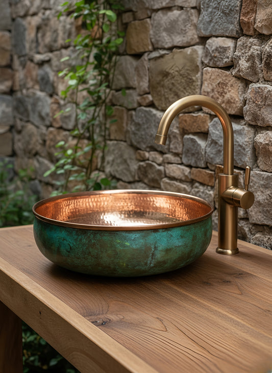 Hammered copper bowl sink with green patina on wood countertop