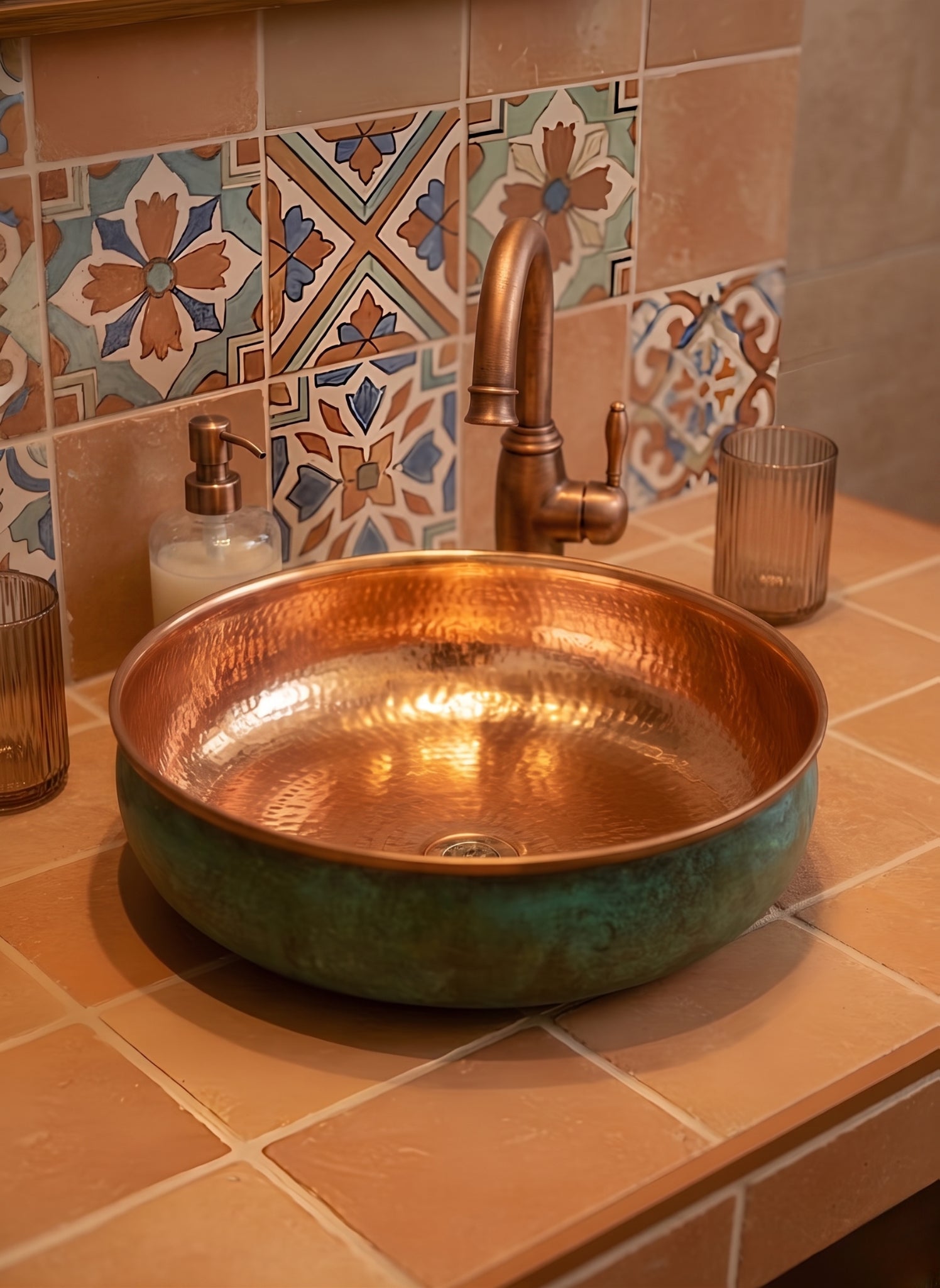 Copper sink with green exterior on patterned tile vanity