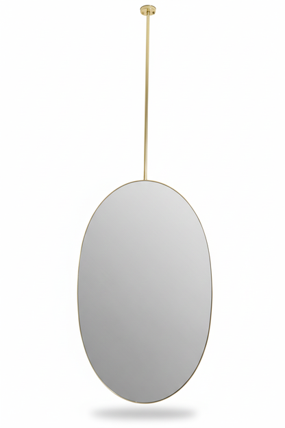 Minimal oval brass mirror suspended from ceiling in a white background