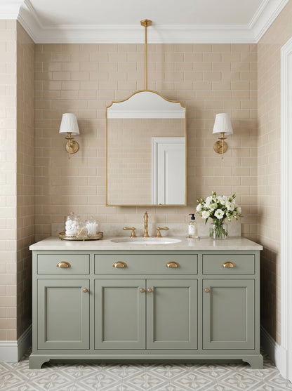 Handmade brass hanging mirror above a traditional bathroom vanity with beige subway tiles.