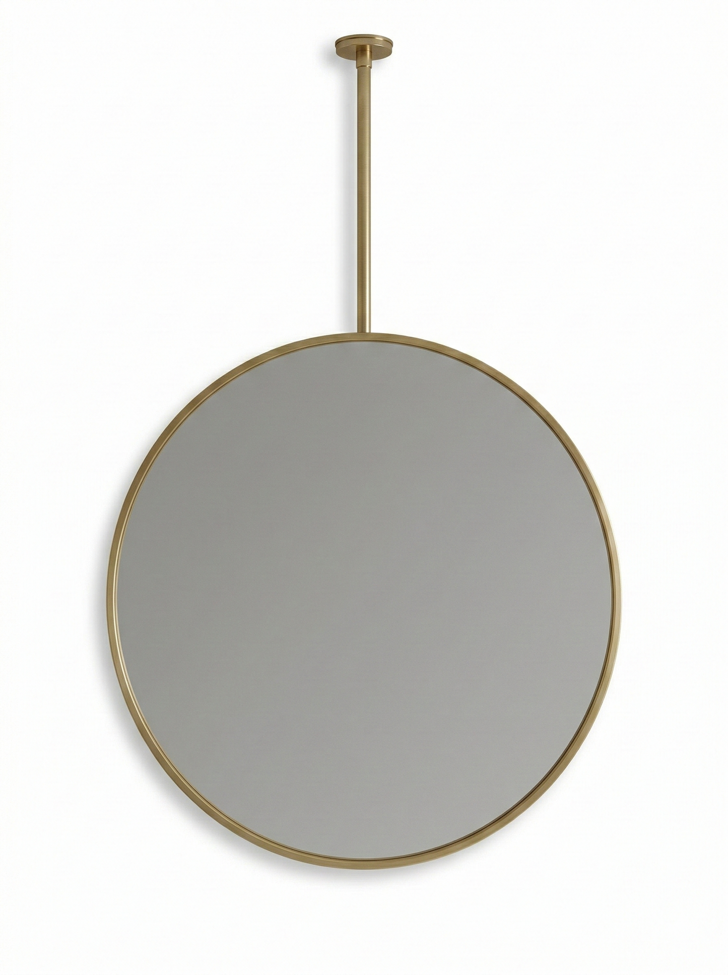 Round brass suspended mirror with ceiling mount on white wall.