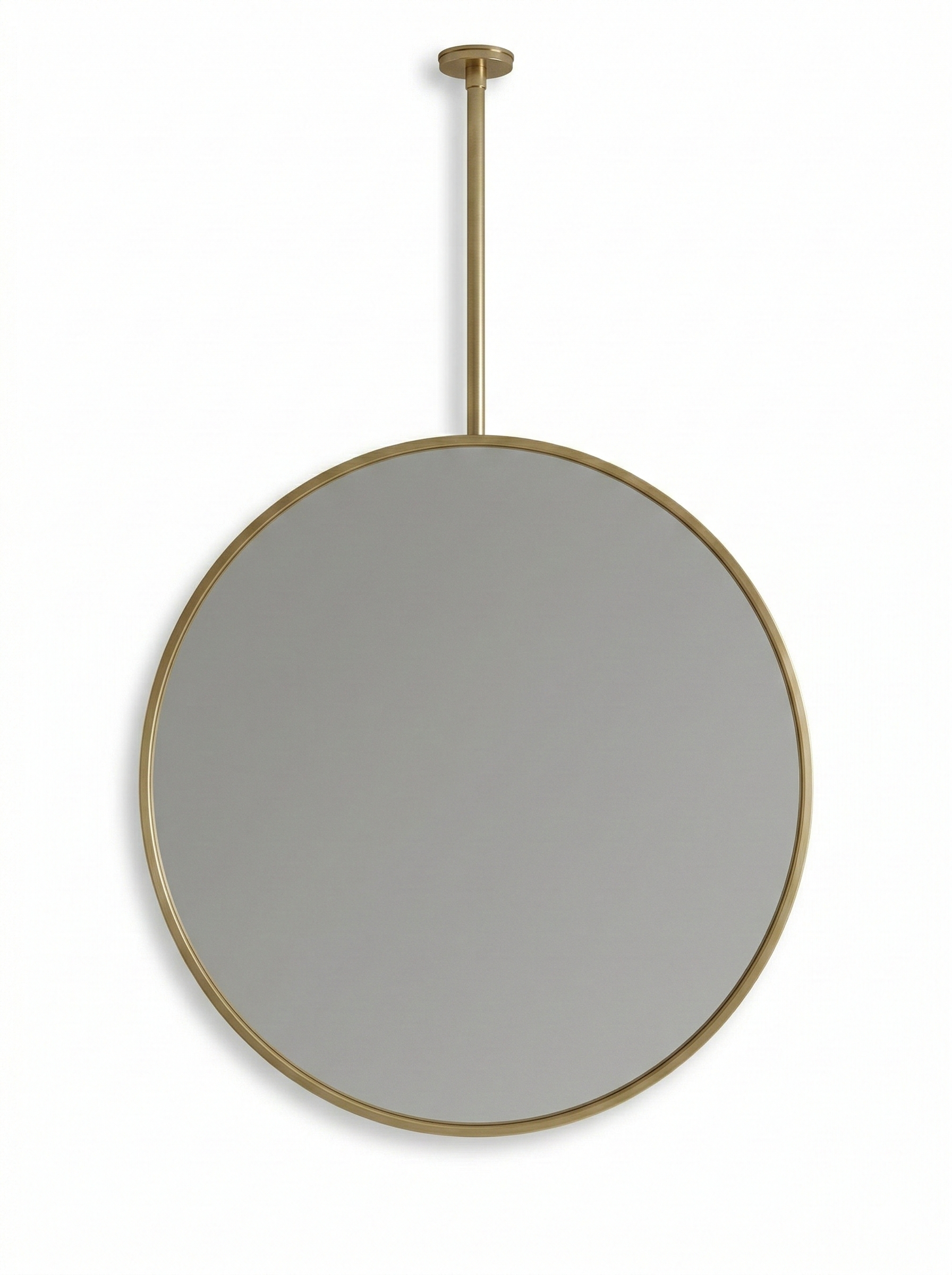 Round brass suspended mirror with ceiling mount on white wall.