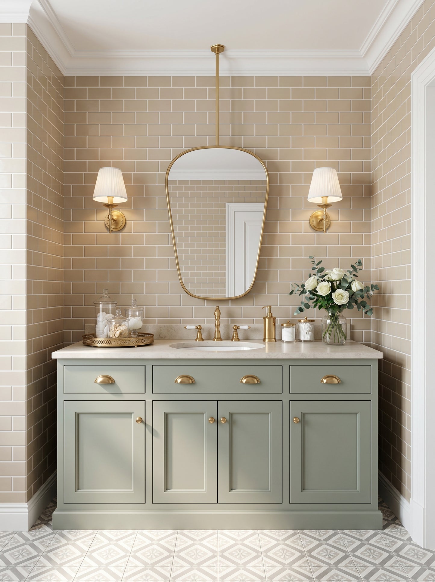 Suspended organic brass mirror above a sage green vanity with brass sconces and beige subway tile bathroom walls.