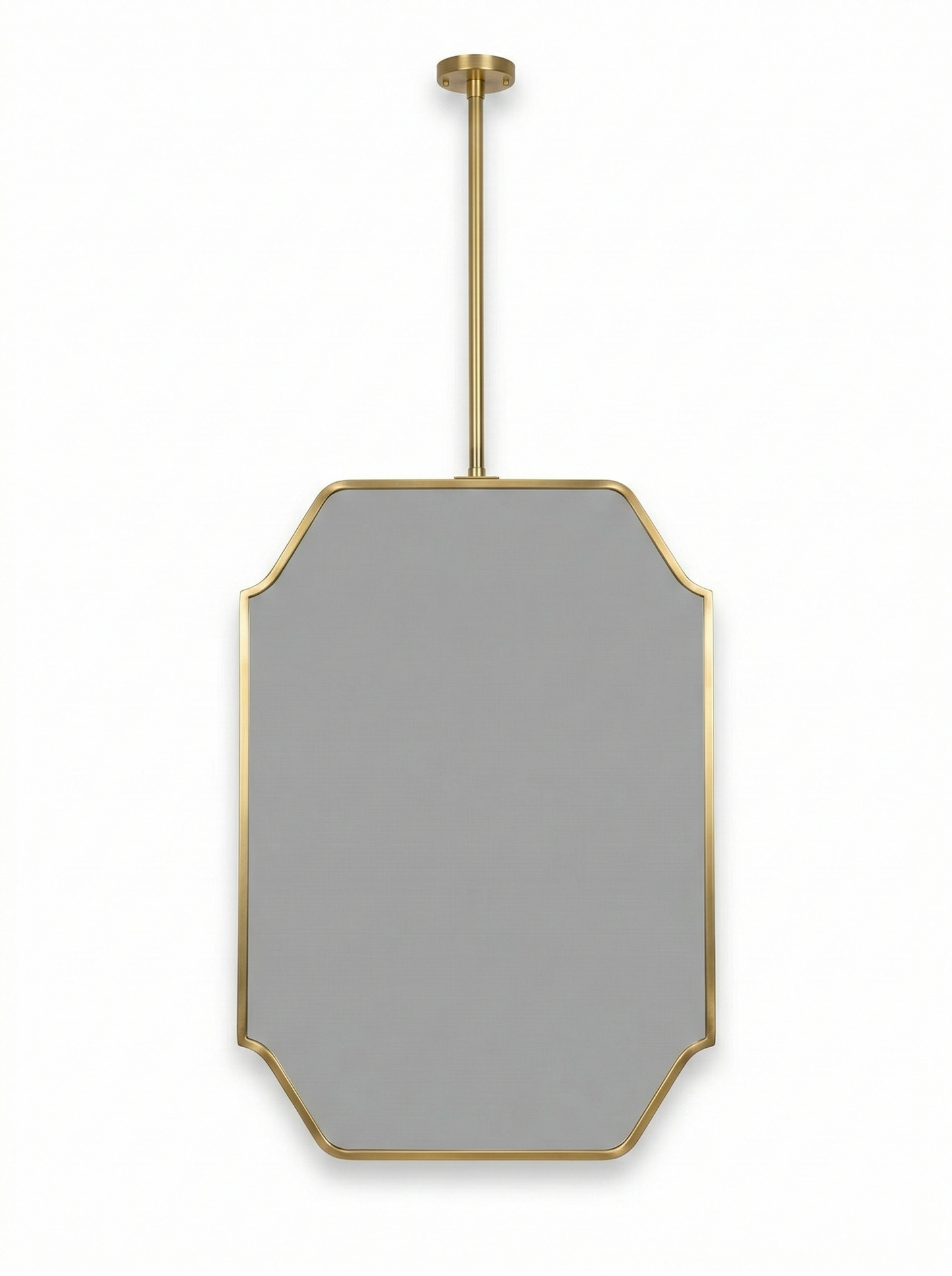 Close-up of modern suspended brass mirror with geometric art deco frame.