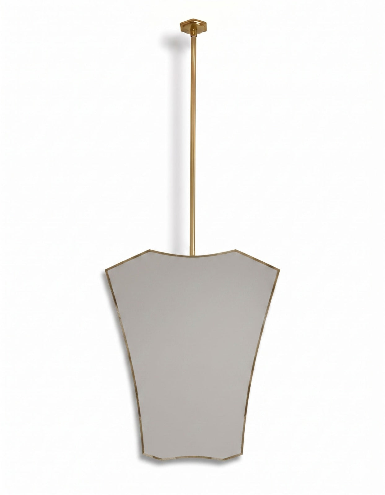 Contemporary gold hanging mirror with decorative crest-shaped brass frame in a white background.