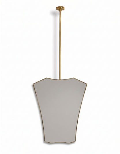 Contemporary gold hanging mirror with decorative crest-shaped brass frame in a white background.