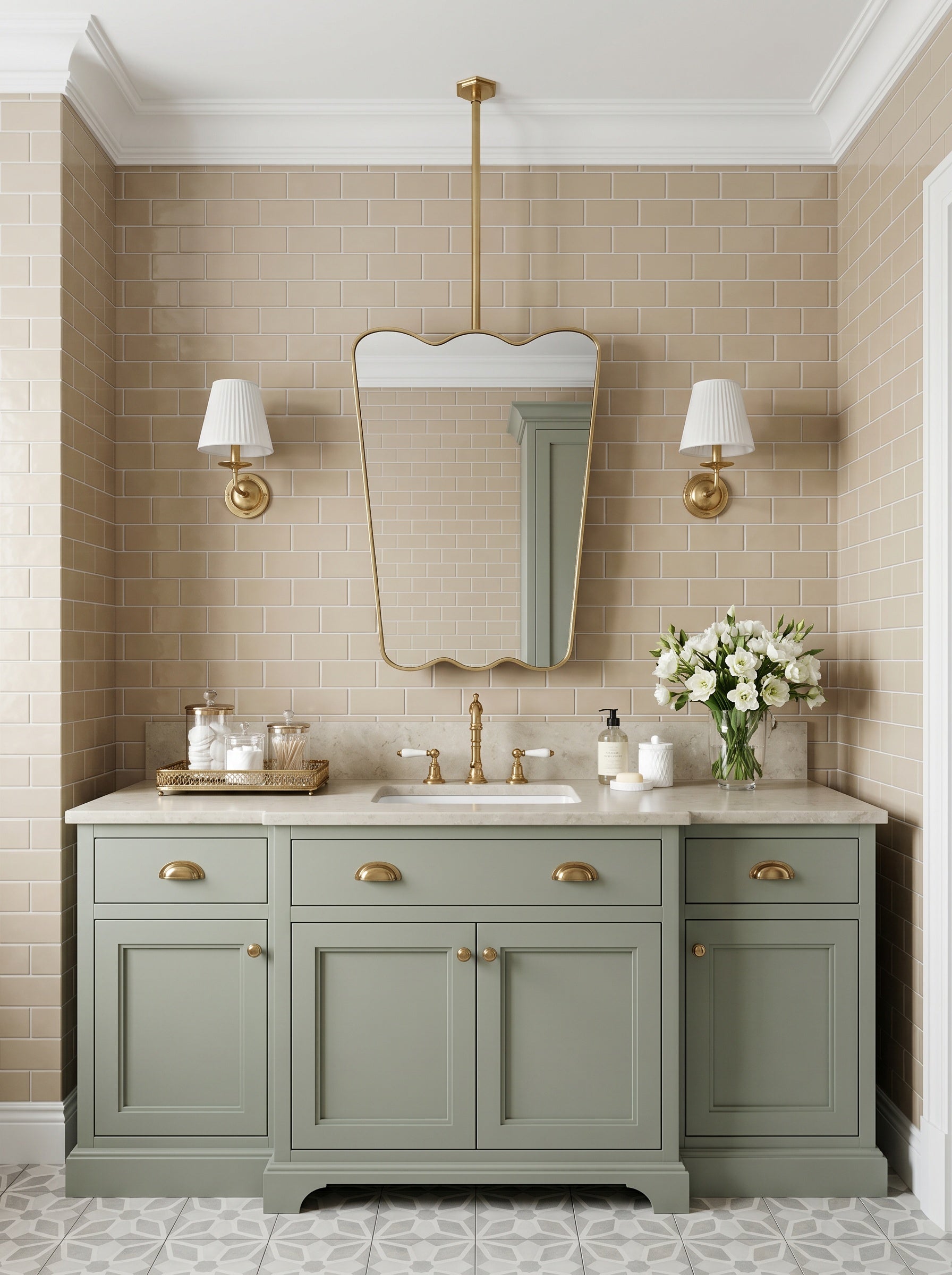 Scalloped brass hanging mirror over a classic green vanity cabinet.