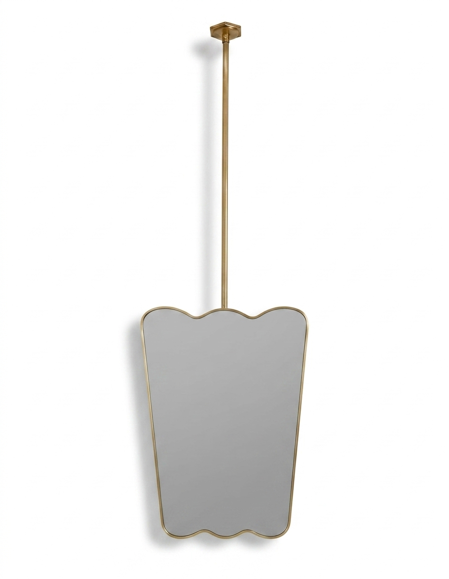 Suspended scalloped brass vanity mirror with ceiling-mounted rod and gold frame.